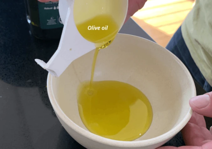 A bowl of olive oil used as a natural leather conditioner and protectant.